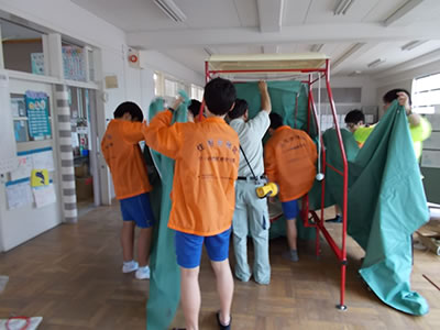 Junior high school students help set up temporary lavatories